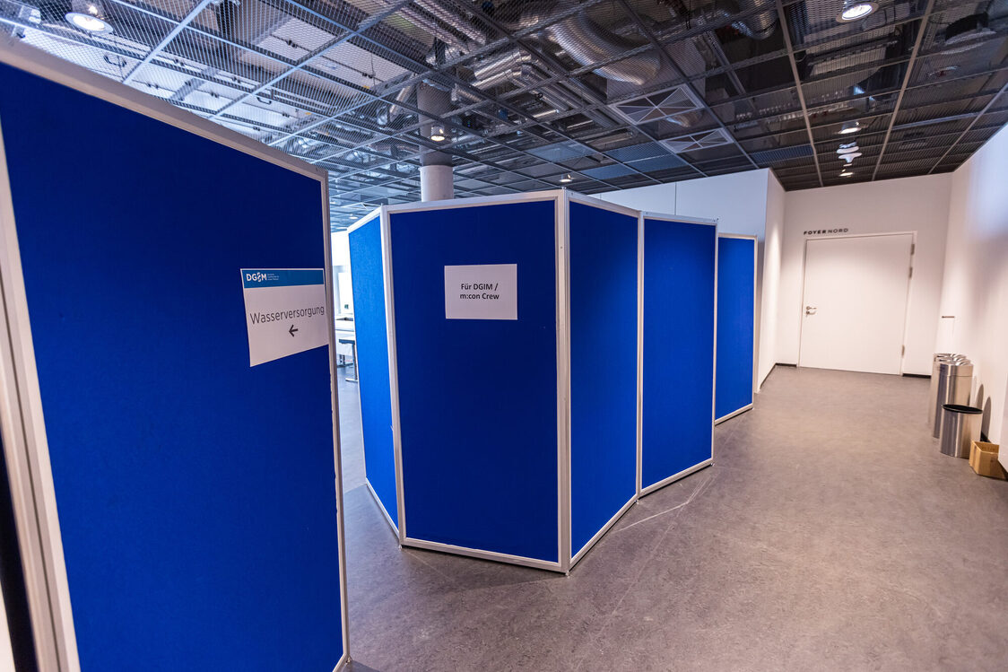 A blue partition wall in the backstage area