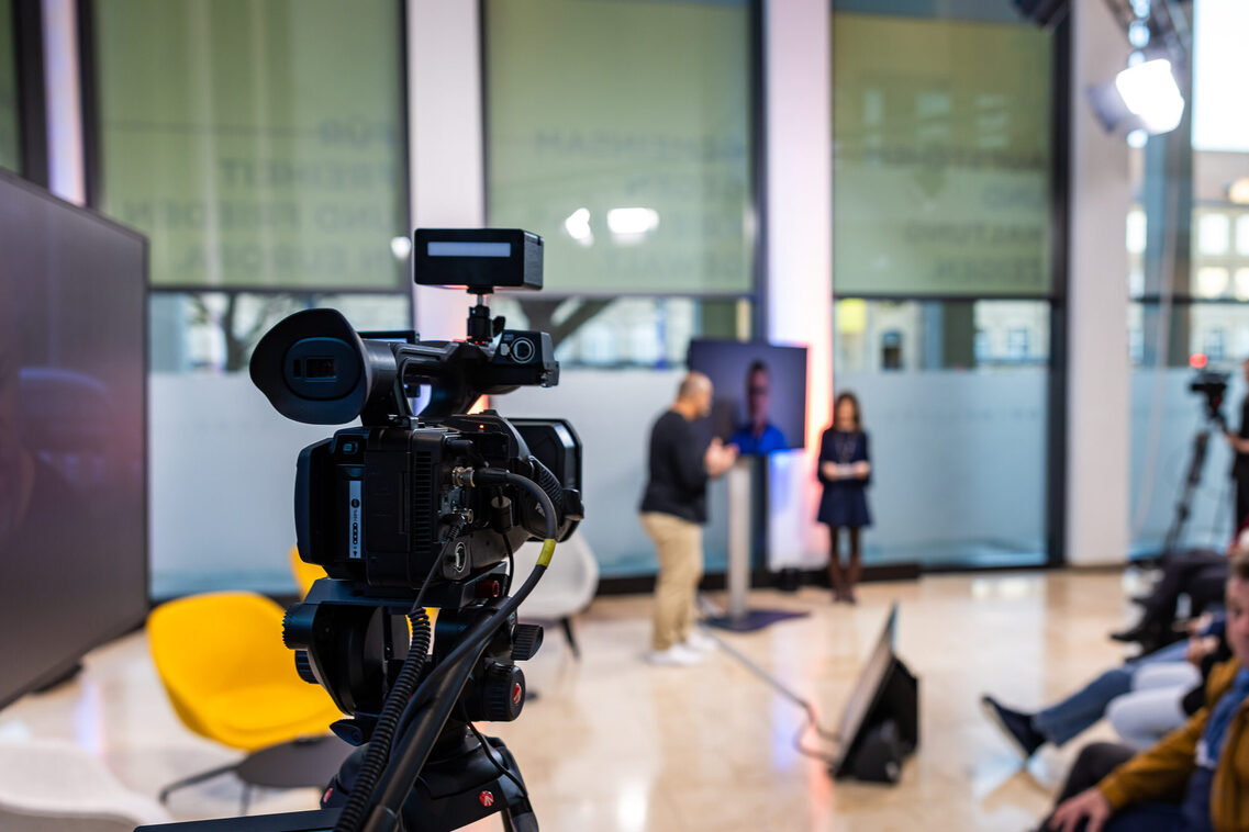 Camera team next to the event visitors