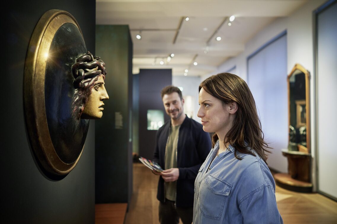 Eine Frau guckt eine Skulptur im Museum an